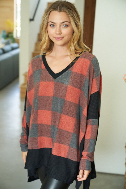 Buffalo Plaid A long sleeve checkered knit top with a V-neck featuring a solid waffle knit