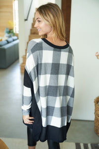 Buffalo Plaid A long sleeve checkered knit top with a V-neck featuring a solid waffle knit