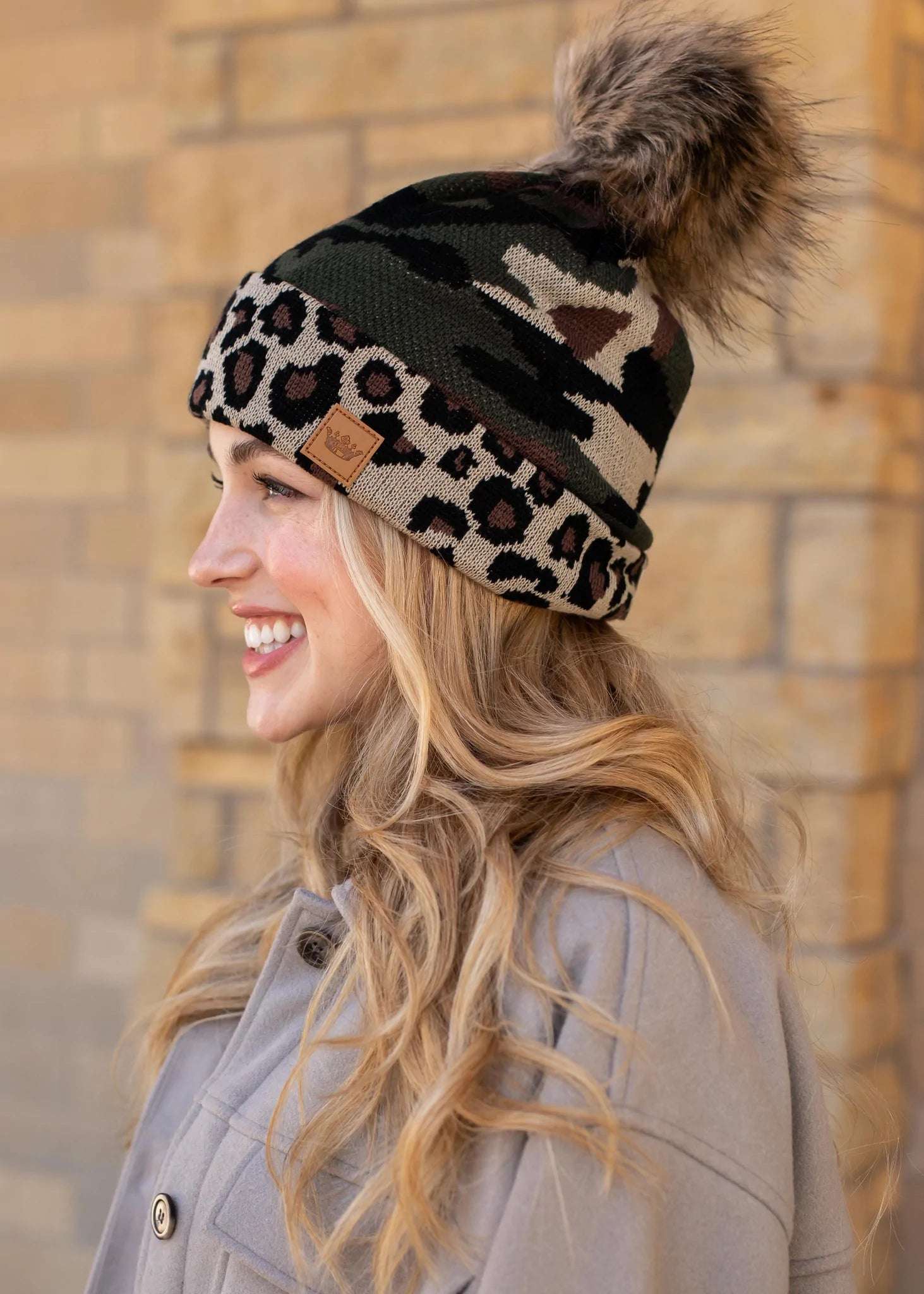 Camo print knit hat with Leopard print trim Natural faux fur pom accent