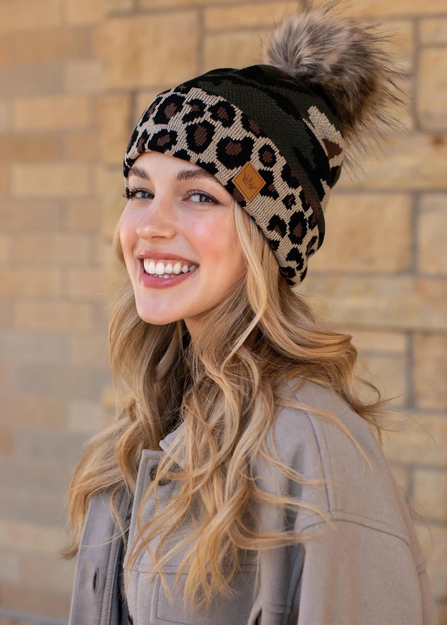 Leopard print knit hat Camo print trim Natural faux fur pom accent