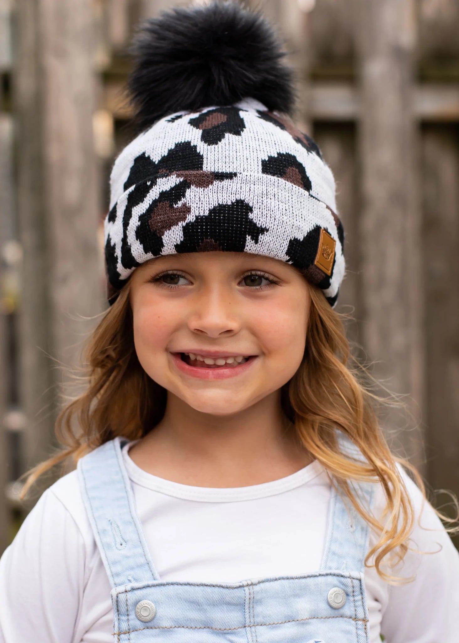 Kids white leopard knit hat Black faux fur pom accent