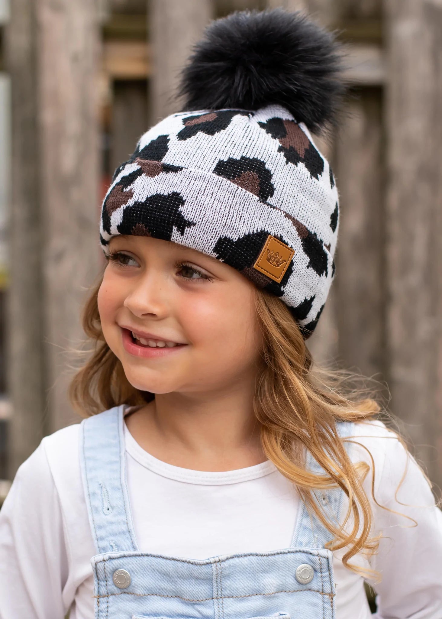 Kids white leopard knit hat Black faux fur pom accent