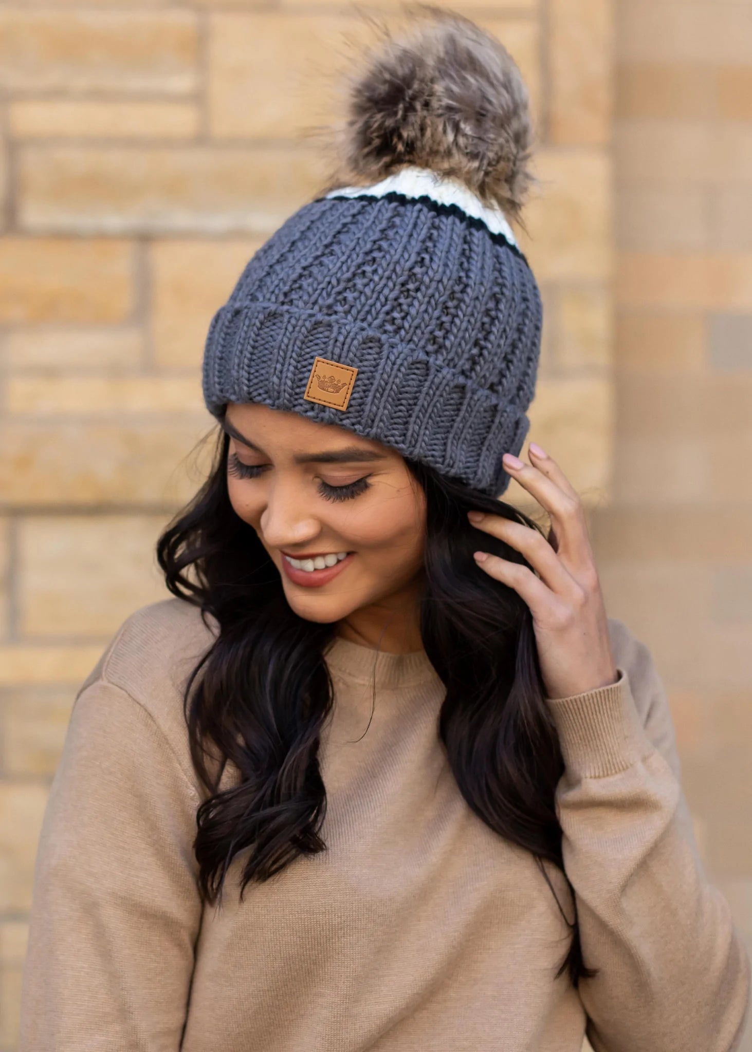 Grey and cream color block with black stripe fleece lined knit hat with pom