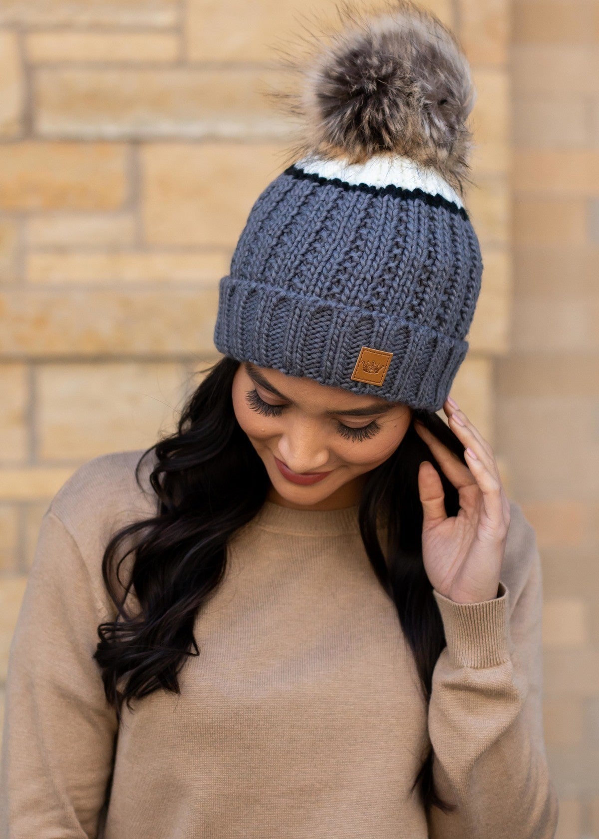Grey and cream color block with black stripe fleece lined knit hat with pom